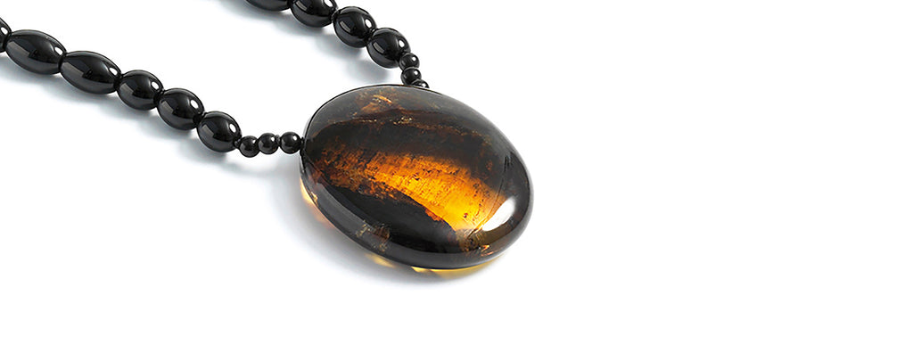Dominican amber disc pendant and ornament, onyx sautoir.