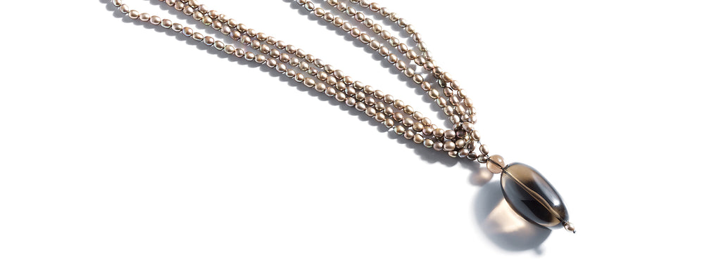 Smoked Pearls necklace: Smoky quartz oval pendant on multi strand rice shaped freshwater pearls.