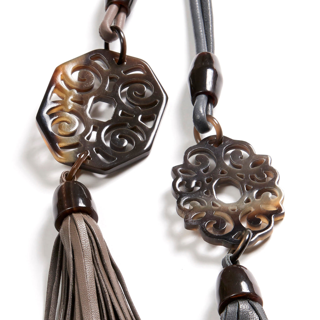 Elsa and Sandra necklaces: Carved buffalo horn rectangular and floral Artdeco pendants. Adjustable Nappa leather bands and tassels.