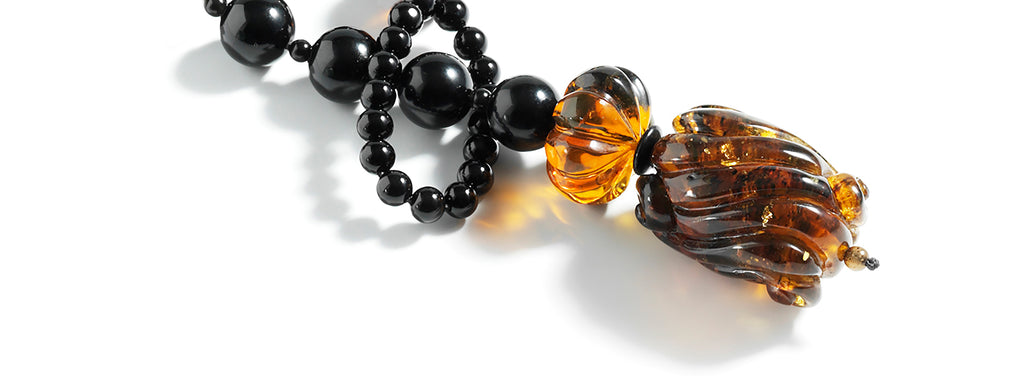Carved Dominican amber pendant and ornaments, onyx lariat.
