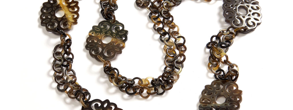 Floral Rings: Repeating Artdeco floral pendants on double rings necklace in buffalo horn.