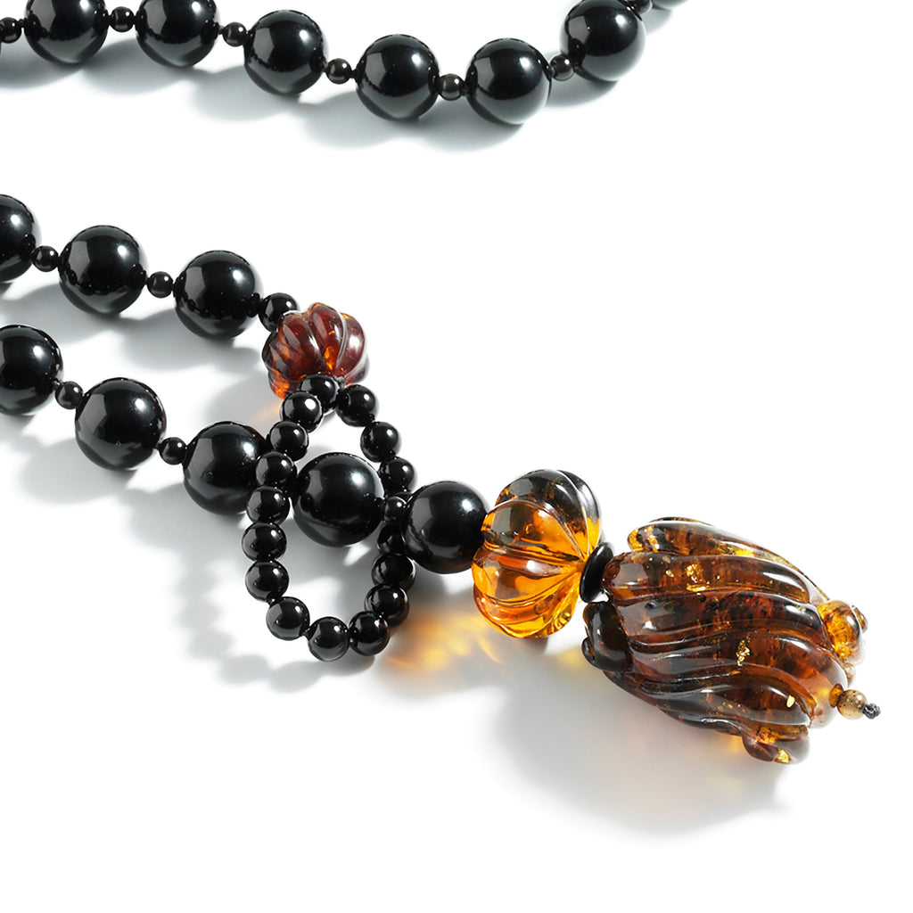 Carved Dominican amber pendant and ornaments, onyx lariat.