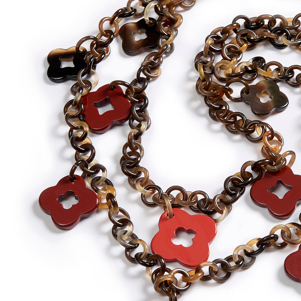 Hanging Flowers necklace: Lacquered cut out floral pendants on rings sautoir in lacquered buffalo horn.
