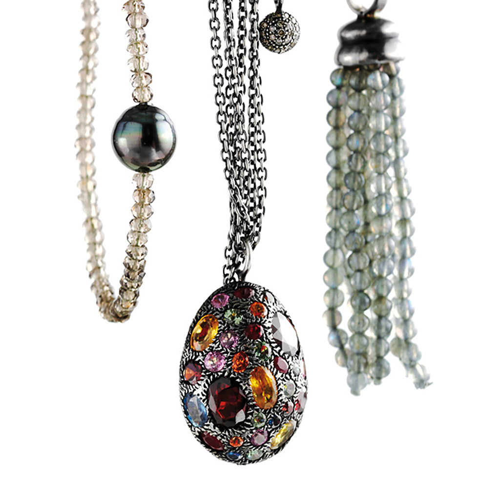 Delhi Group necklaces: Tahitian pearl on smoky quartz collier, multi strand blackened necklace, multi coloured saphire pendant, pavé pendant, labradorite tassel on labradorite necklace.
