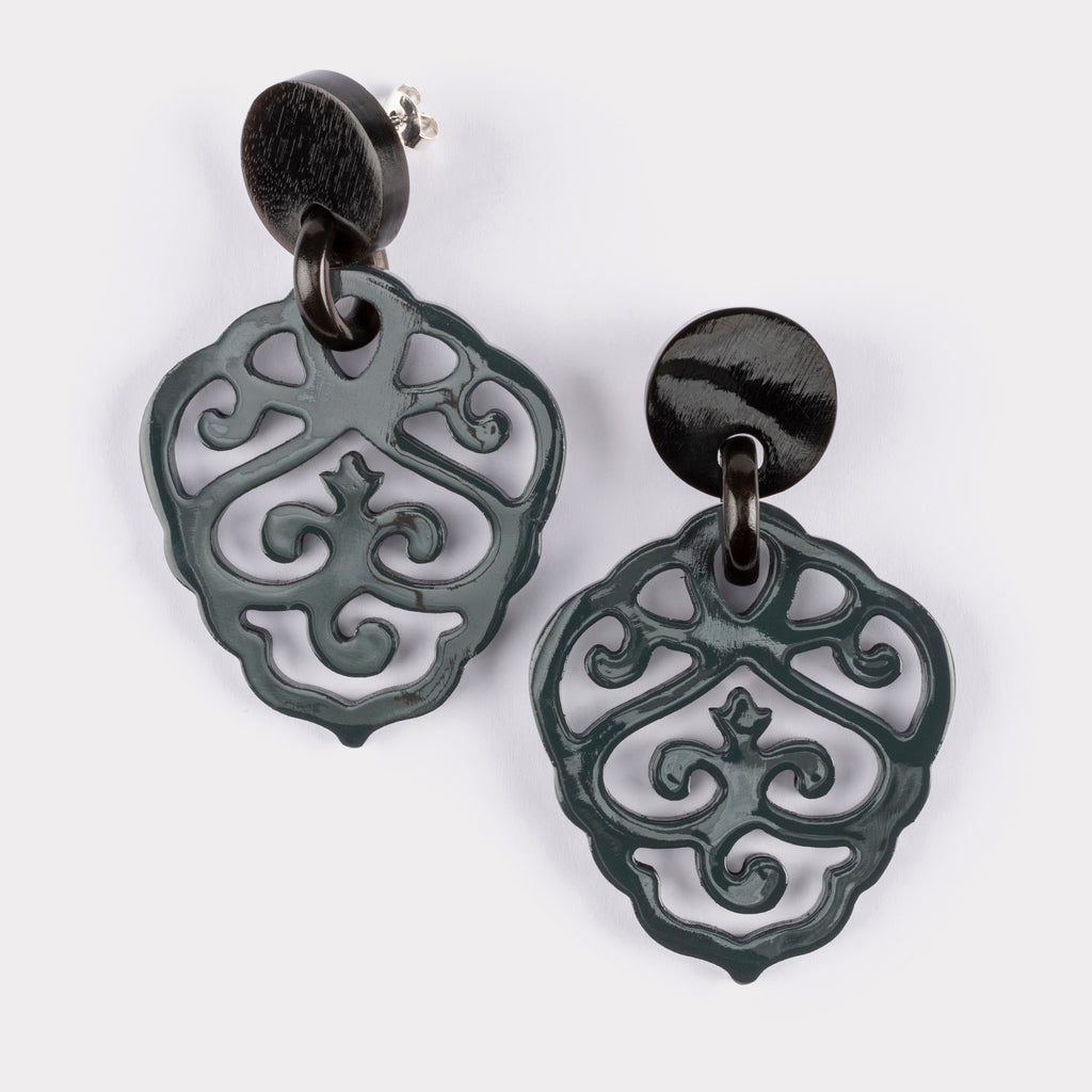 Carved ornament earrings in  lacquered buffalo horn.
